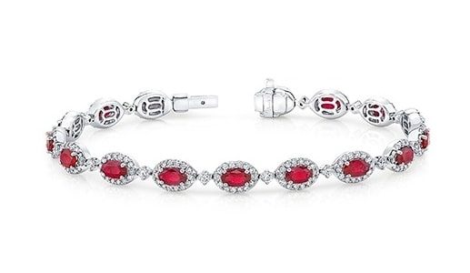 A ruby halo tennis bracelet from Uneek features white gold and diamonds.