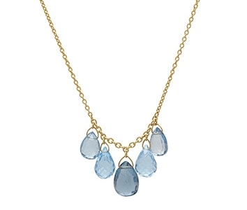 A blue topaz necklace from Gurhan features a gold cable chain.