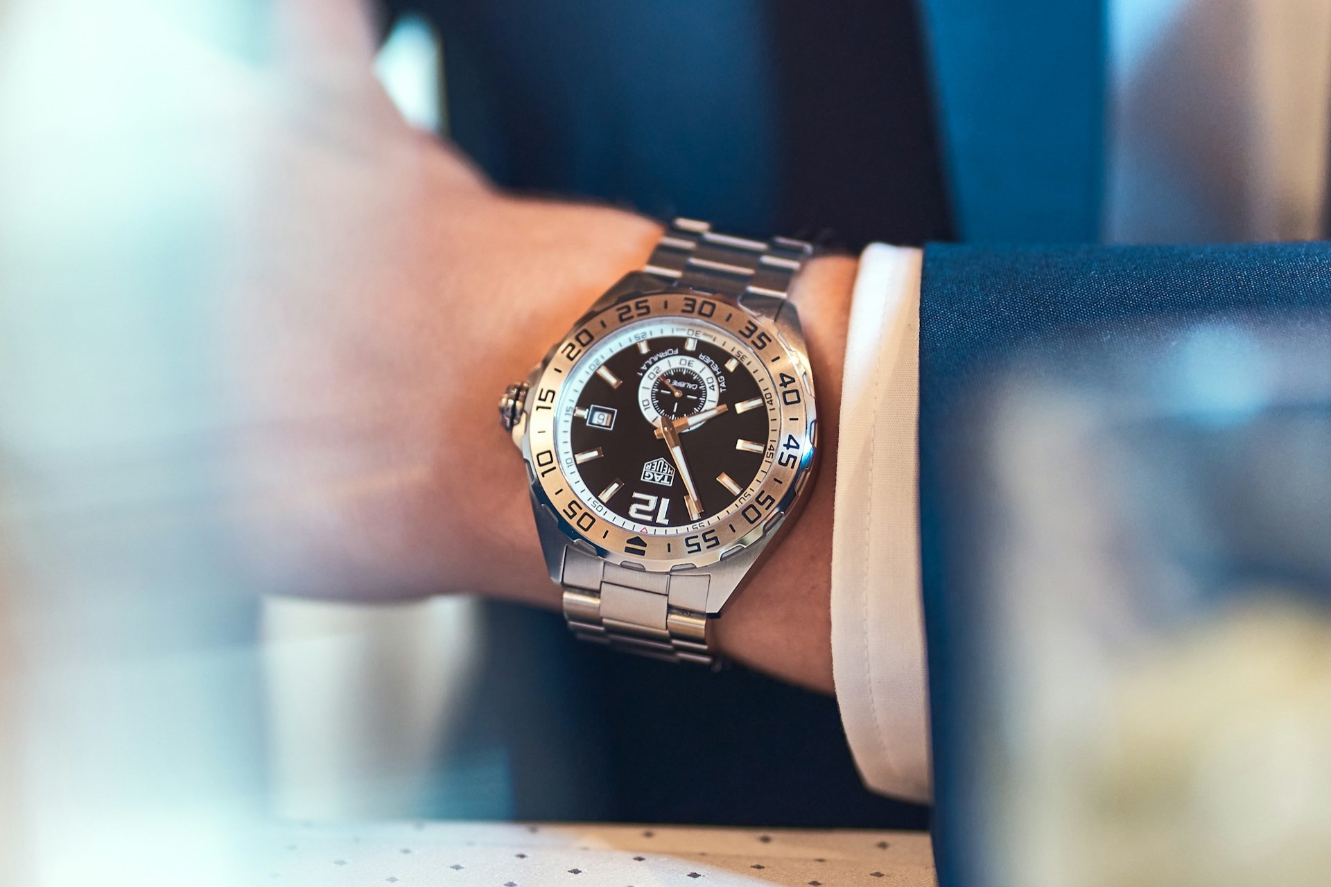A close-up image of a man’s wrist adorned with a TAG Heuer watch