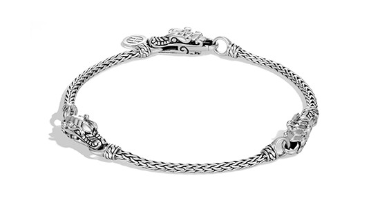 a white gold chain bracelet featuring three dragon’s head motifs