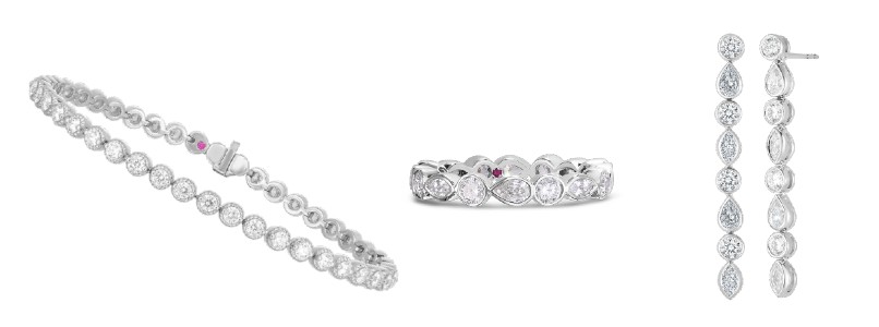 A diamond tennis bracelet, eternity band, and drop earrings by Roberto Coin.