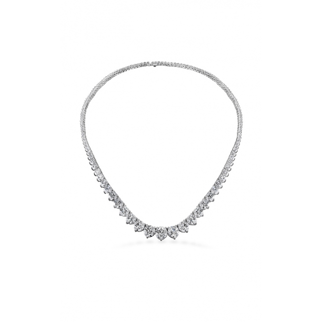 A white gold diamond necklace with graduated teardrop and round diamonds in a V-shape on a white background.