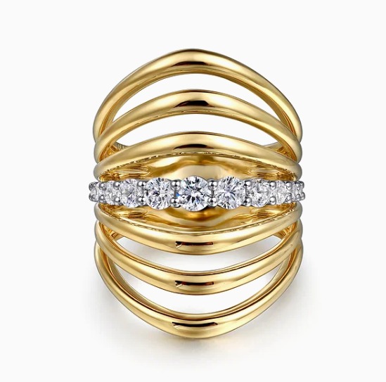 A yellow gold multi band diamond ring on a white background