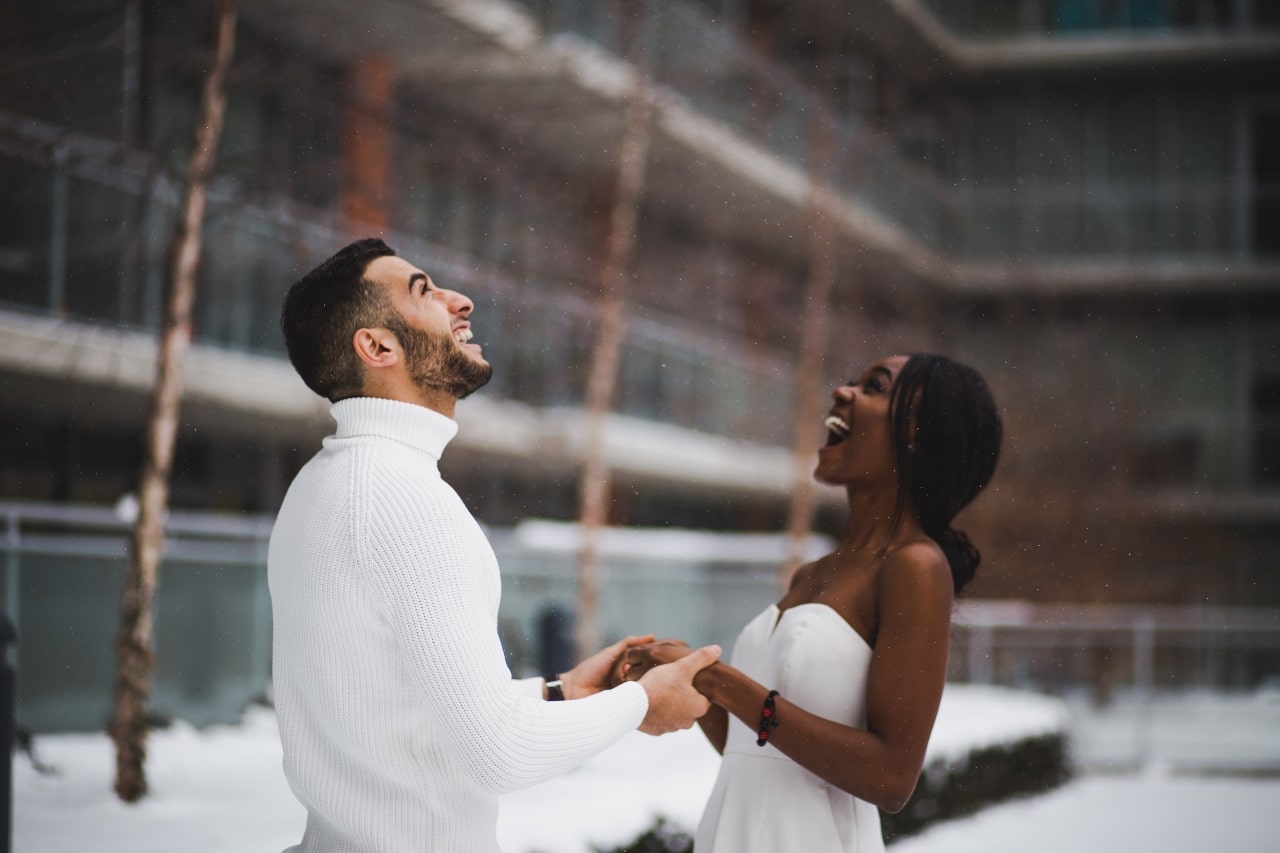 A couple enjoying a moment in the snow on their wedding day.