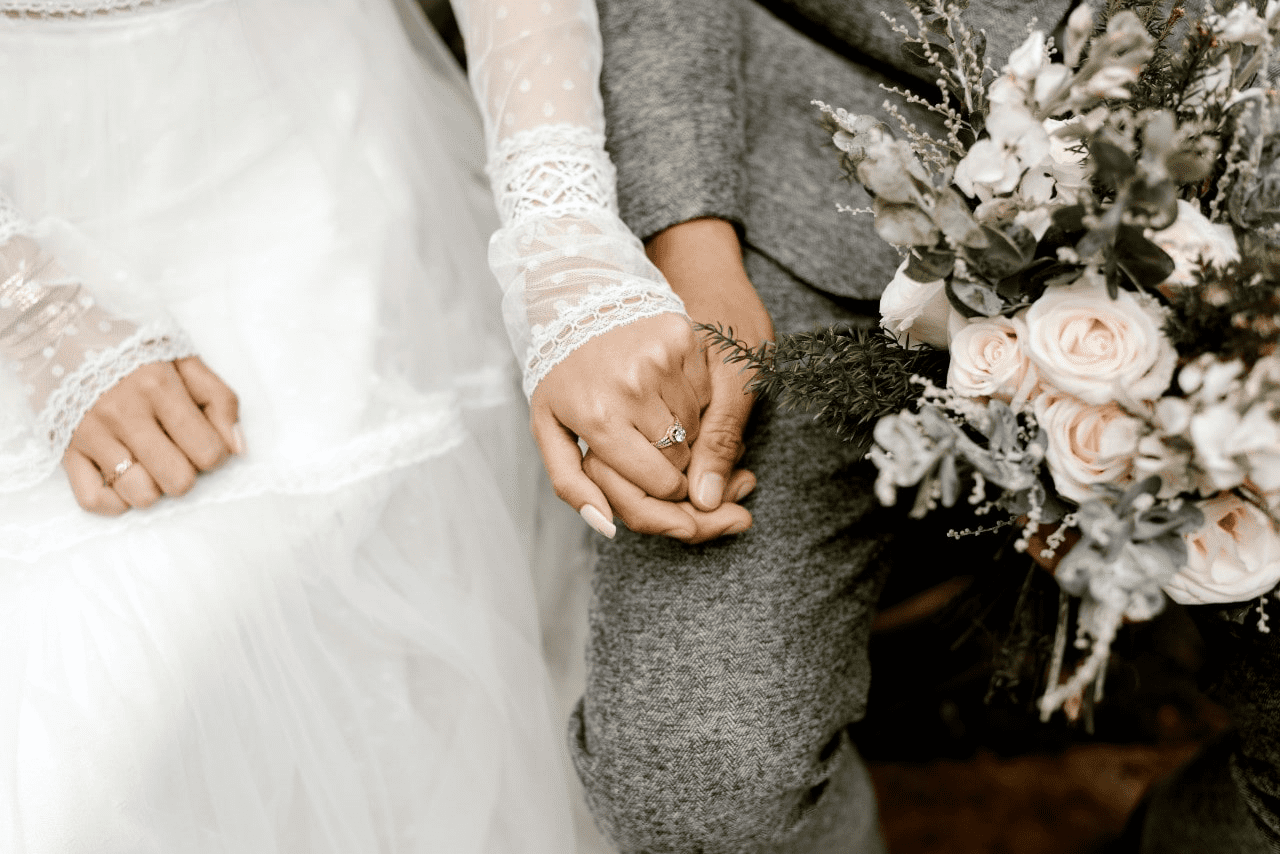 bride and groom holding hands.