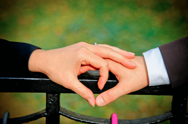 two hands holding on rail two hands holding on rail