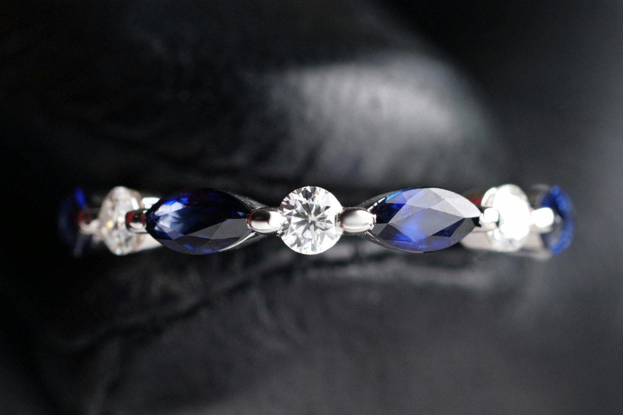 a white gold wedding band set with sapphires and diamonds